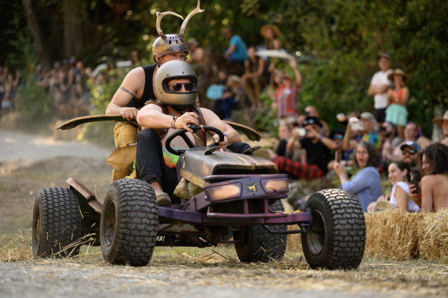 A derby car with costumed riders