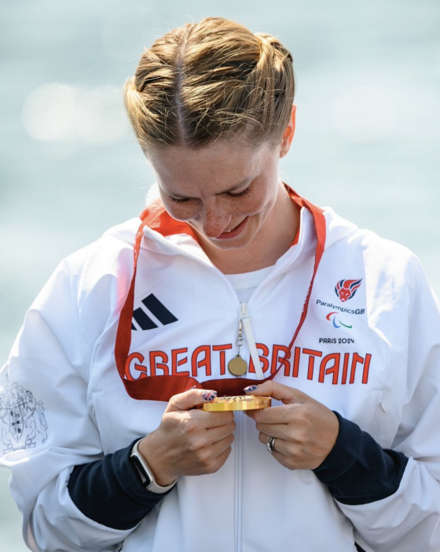 Erin looking at her gold medal