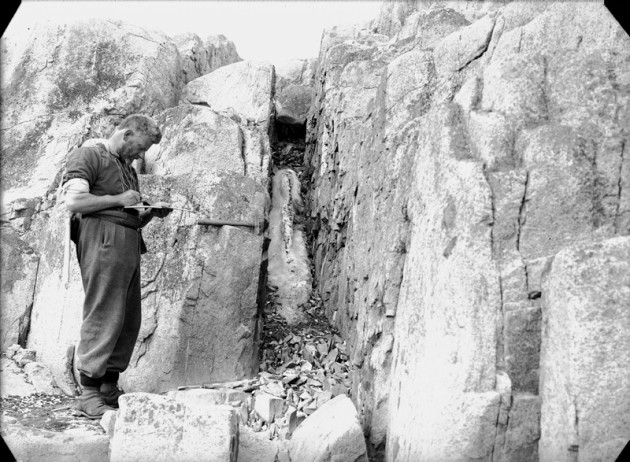 William Flett carrying out geological work at penguin rookery, Antarctica, Operation Tabarin Dec 1944.
