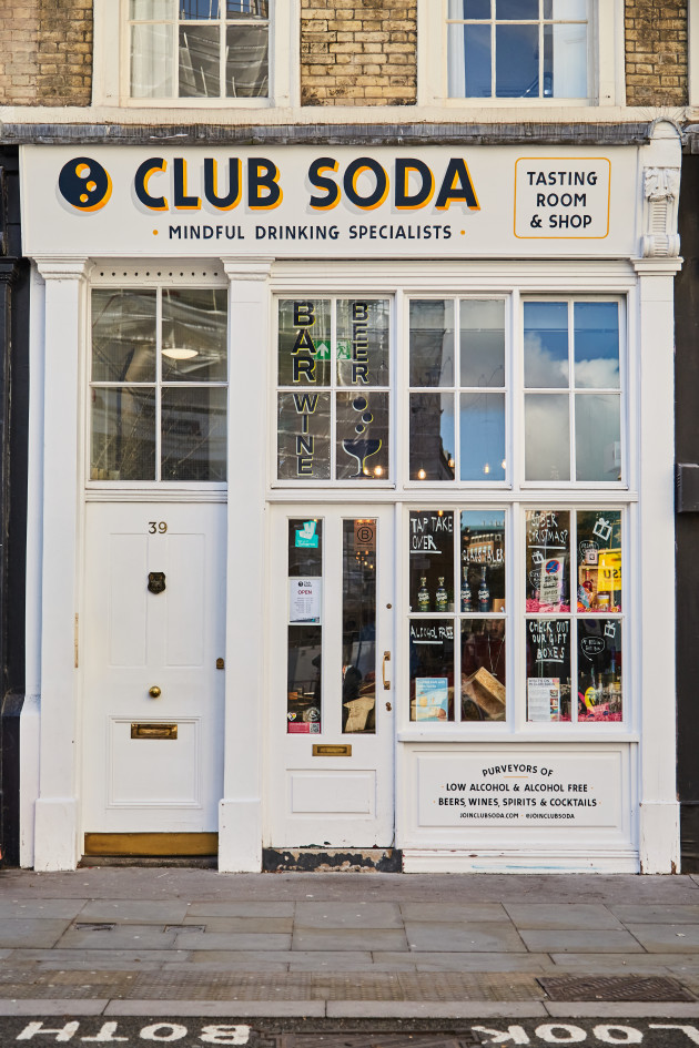 Club Soda's white shop front with a painted sign which reads