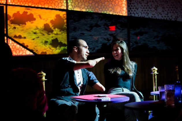 Mahdi The Magician making a young man laugh while performing his magic show