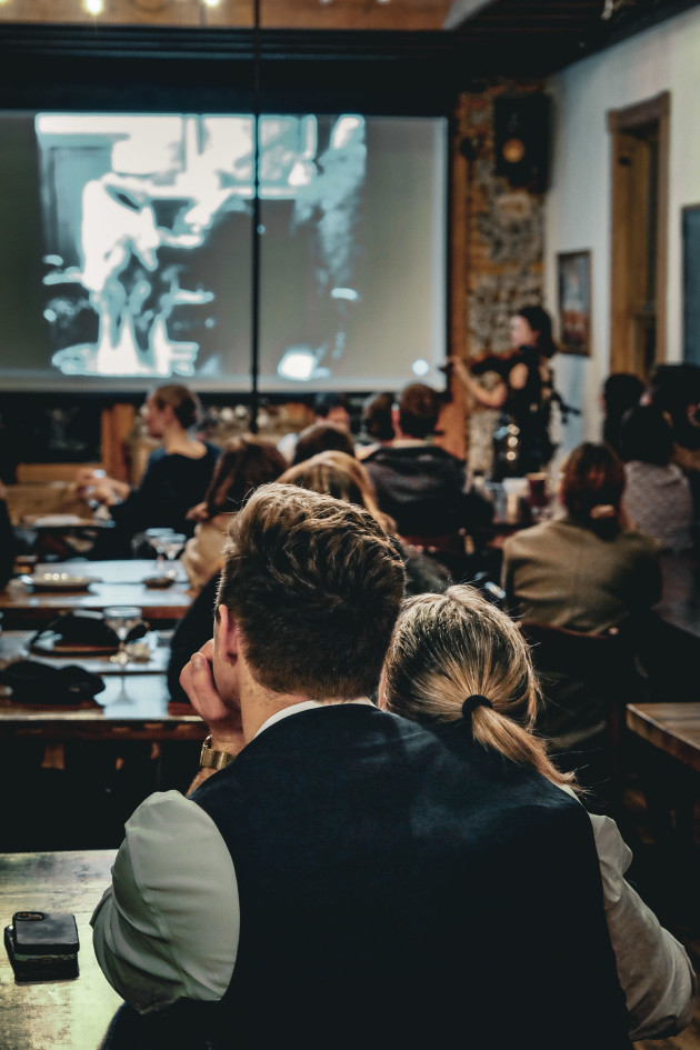 Viewers enjoying a silent movie while listening to live jazz.